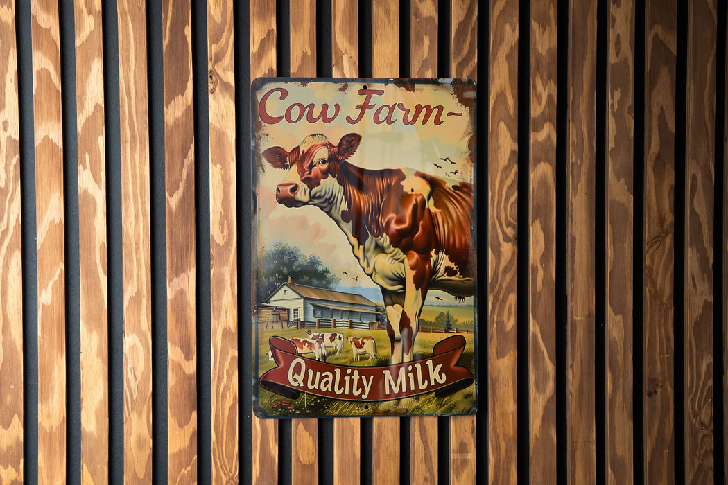 a cow farm sign hanging on a wooden wall