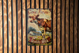a cow farm sign hanging on a wooden wall
