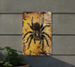 a picture of a spider on a yellow and black sign
