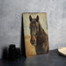 a picture of a horse on a wall next to a plate