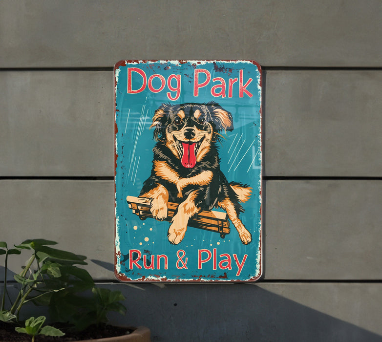 a dog park sign hanging on the side of a building