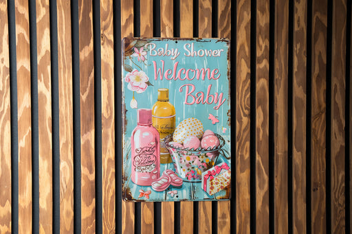 a baby shower sign hanging on a wooden wall