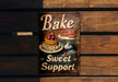 a sign that says bake sweet support on a wooden wall