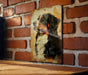 a picture of a dog on a brick wall