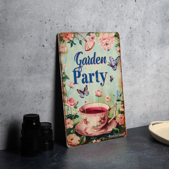 a garden party sign next to binoculars and a plate
