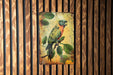 a painting of a parrot on a wooden wall