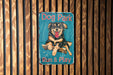 a dog park sign on a wooden wall