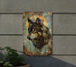 a painting of a wolf on a wall next to a potted plant