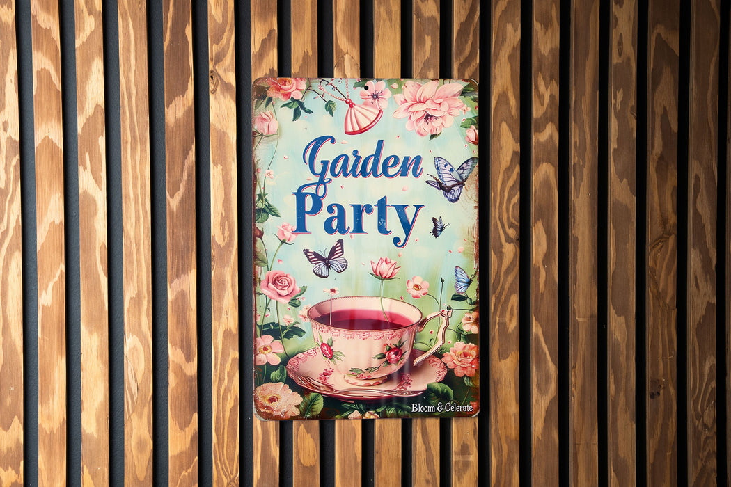 a garden party sign hanging on a wooden wall