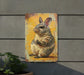 a metal sign with a picture of a rabbit on it
