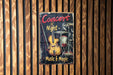 a concert poster hanging on a wooden wall
