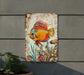a painting of a fish on a wall next to a potted plant