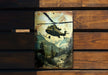 a painting of a helicopter flying over a forest