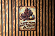 a sign on a wooden wall that says chocolate delights