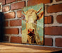a picture of a cow on a brick wall