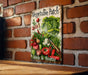 a vegetable patch sign on a brick wall