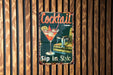 a sign on a wooden wall that says cocktail sip in style