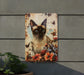 a picture of a siamese cat on a wall