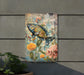 a painting of a fish on a wall next to a potted plant