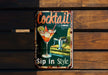 a metal sign that says cocktail sip in style