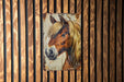 a picture of a horse on a wooden wall