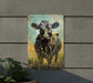 a painting of a cow is hanging on a wall