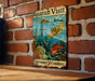 a sign on a brick wall that says aquarium visit