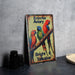 a metal sign with three parrots sitting on a branch
