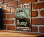a rusted metal sign on a brick wall