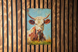 a painting of a cow on a wooden wall