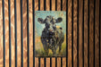 a picture of a cow on a wooden wall