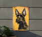 a yellow sign with a black dog on it