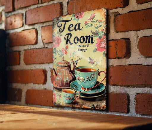 a picture of a tea room sign on a brick wall