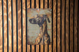 a picture of a giraffe on a wooden wall