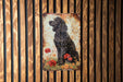 a painting of a black dog on a wooden wall