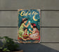 a metal sign with a picture of two girls on it