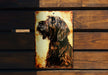 a picture of a dog on a metal plaque