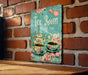 a tea room sign on a brick wall
