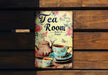 a tea room sign on a wooden bench