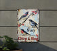 a sign on the side of a building with birds on it