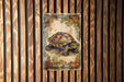 a painting of a turtle on a wooden wall