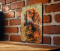 a picture of a dog on a brick wall