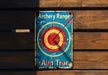 a sign on a wooden wall that says archery range