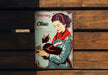 a tin can with a picture of a woman holding a cat