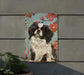 a painting of a dog on a wall next to a potted plant