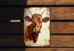 a picture of a cow on a wooden wall