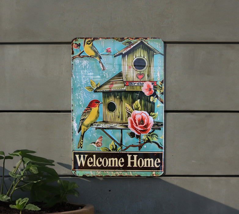 a welcome home sign on the side of a building