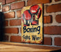 a sign on a brick wall that says boxing fight and win