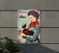 a metal sign with a woman holding a cat