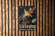 a wooden wall with a sign that reads listening to the universe